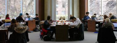 Students studying at tables inside a Թϱ library. 